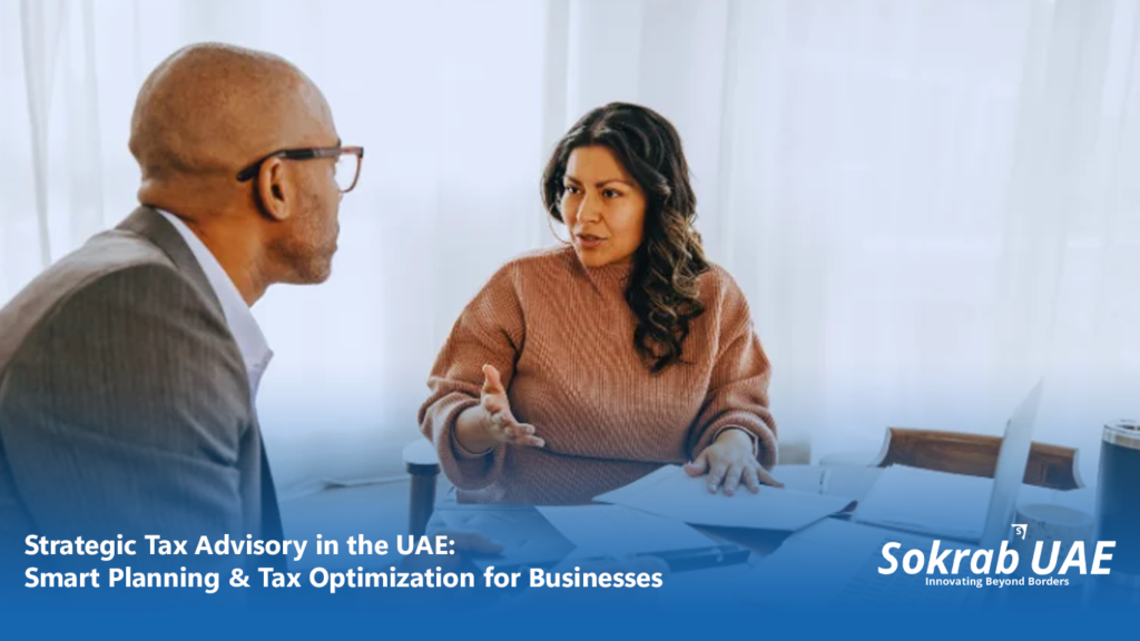 Professional tax consultant in UAE office reviewing corporate tax planning documents and financial reports with client