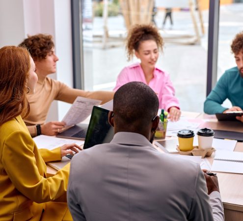 Business colleagues in modern office, planning strategy and brainstorming, colleagues thinking concept. good-looking men and women gathered together for meeting, discuss ideas and plans